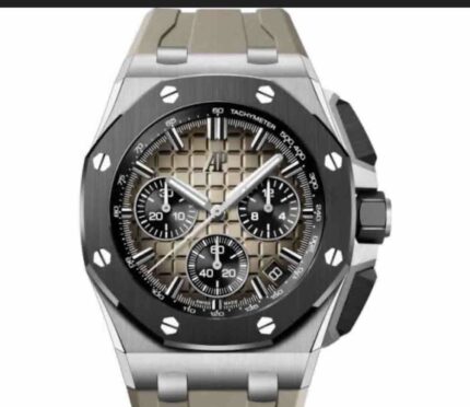 Close-up image of a luxury watch crown and part of the bezel with polished metal finish and engraved details.