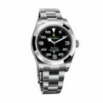 Replica Rolex Oyster Perpetual 114200 watch with vibrant blue dial and stainless steel case, shown from the left side.